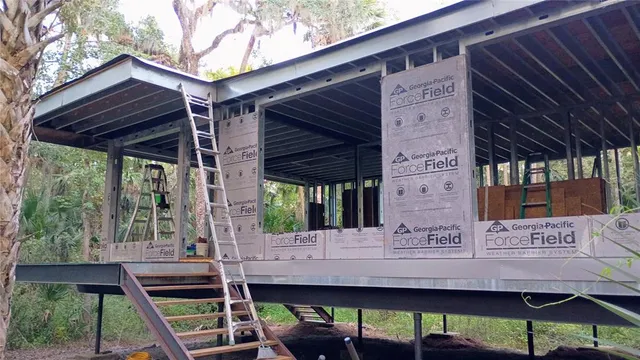 a view of staircase with two couches and a potted plant on a table