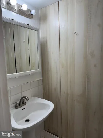 a bathroom with a sink and mirror