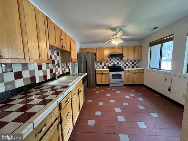 a kitchen with stainless steel appliances granite countertop a stove and a sink