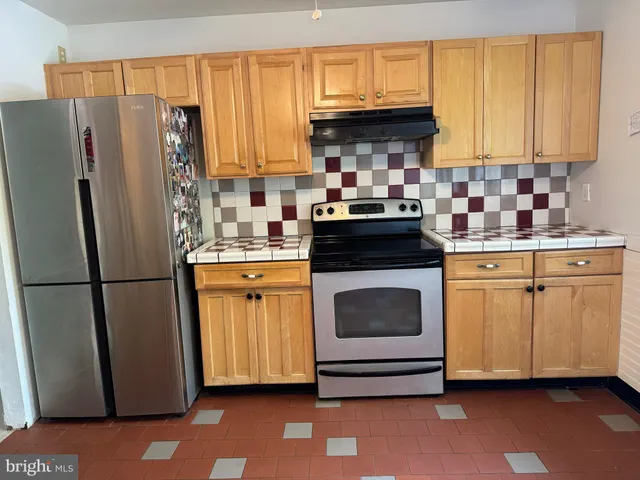a kitchen with a white cabinets and appliances