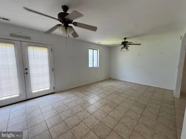 a view of an empty room and a window