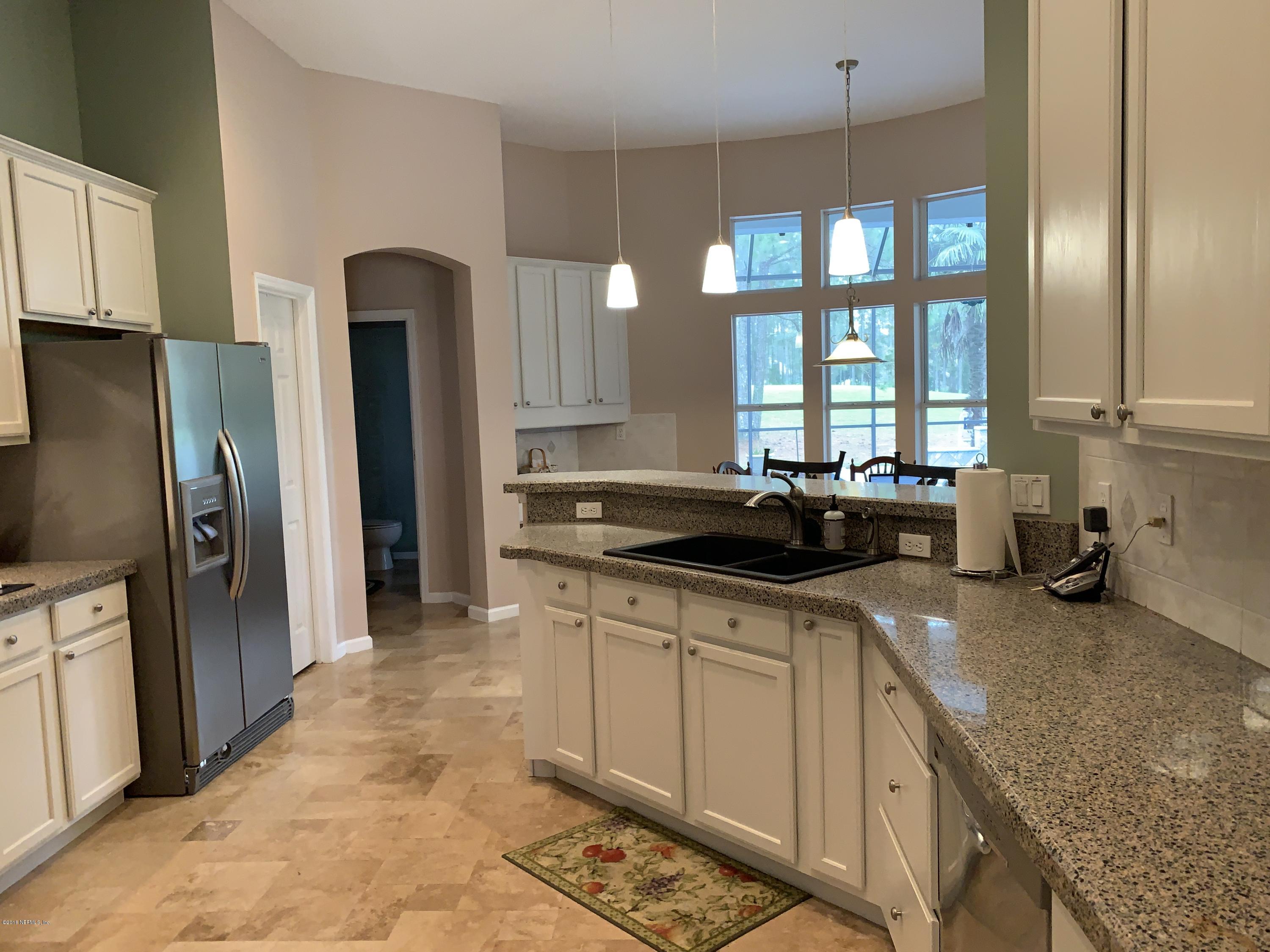 1925 Lyndhurst Drive St. Augustine, FL 32092 - Photo 13 of 52 a kitchen with stainless steel appliances granite countertop a sink stove and refrigerator