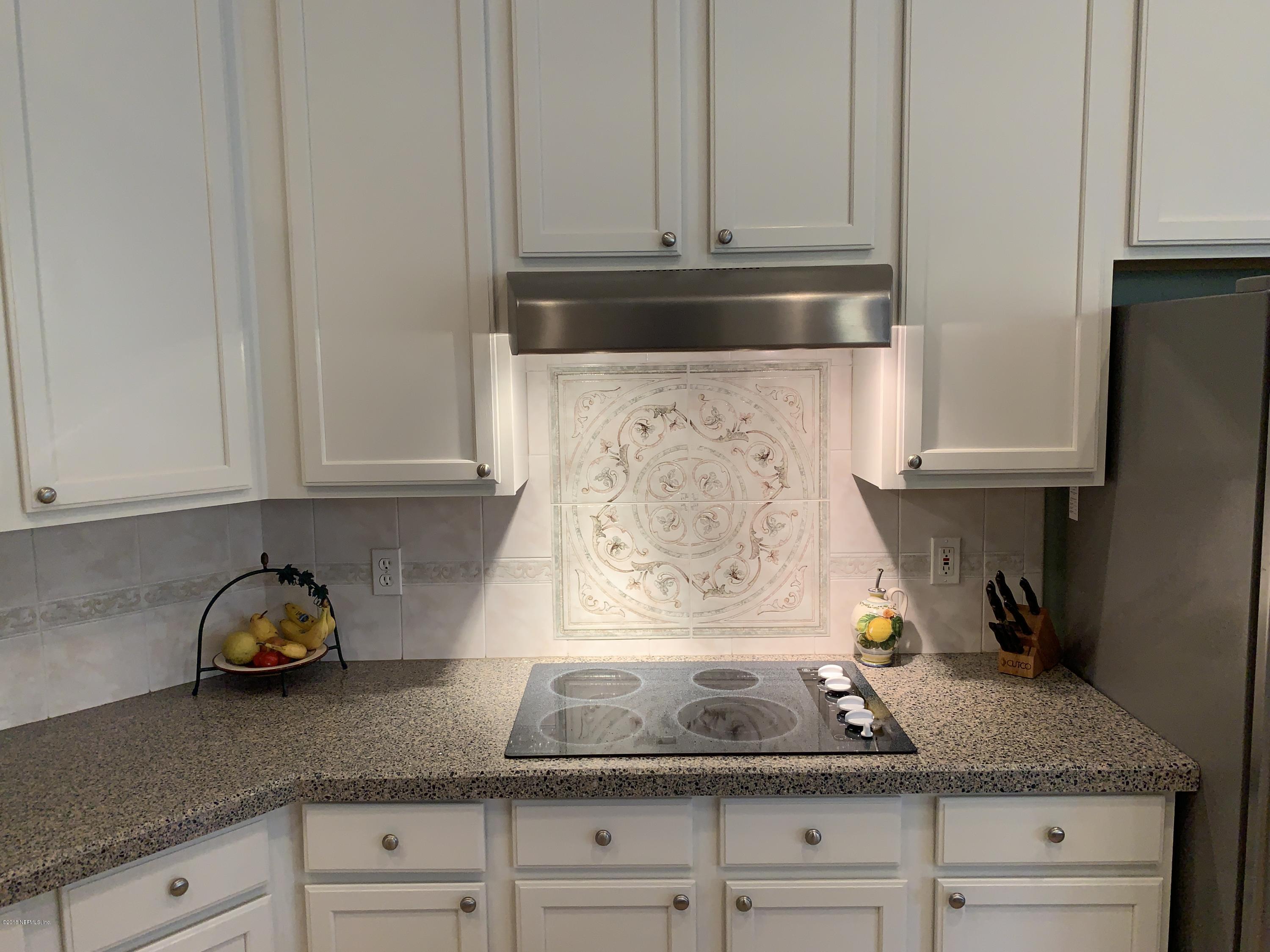 1925 Lyndhurst Drive St. Augustine, FL 32092 - Photo 14 of 52 a kitchen with granite countertop white cabinets and a stove