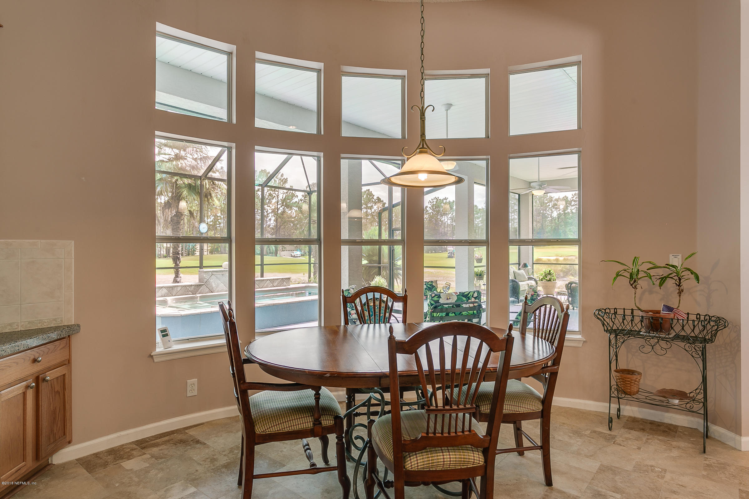 1925 Lyndhurst Drive St. Augustine, FL 32092 - Photo 16 of 52 a view of a dining room with furniture large windows and wooden floor
