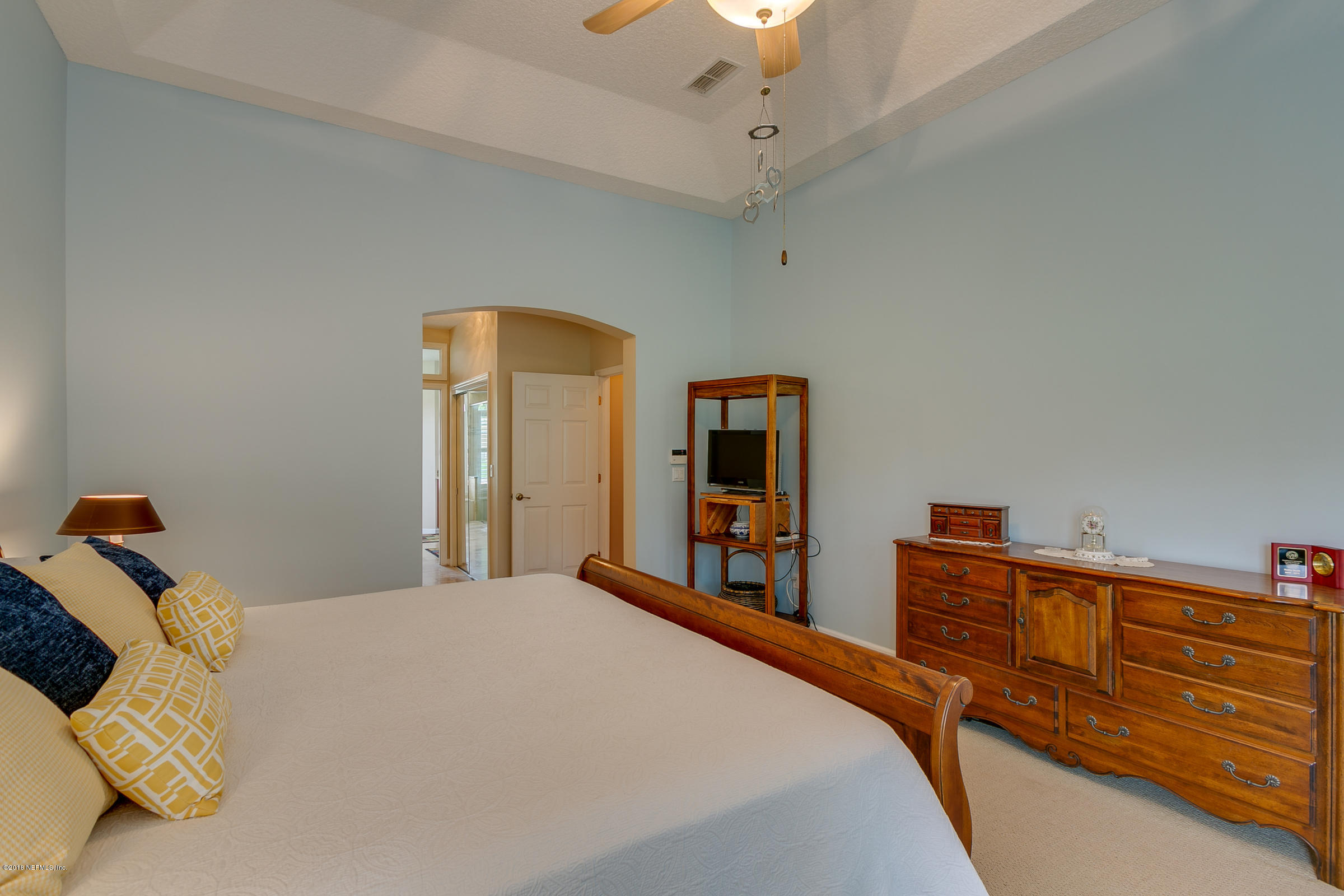 1925 Lyndhurst Drive St. Augustine, FL 32092 - Photo 18 of 52 a bedroom with a bed and a chandelier