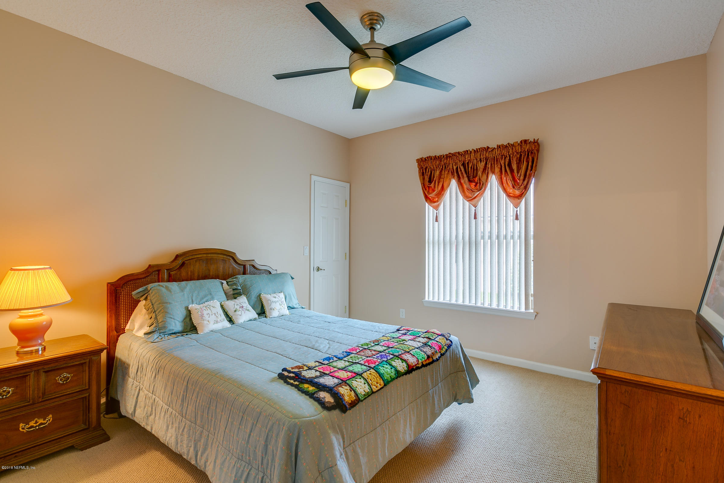 1925 Lyndhurst Drive St. Augustine, FL 32092 - Photo 33 of 52 a bedroom with a bed and a chandelier