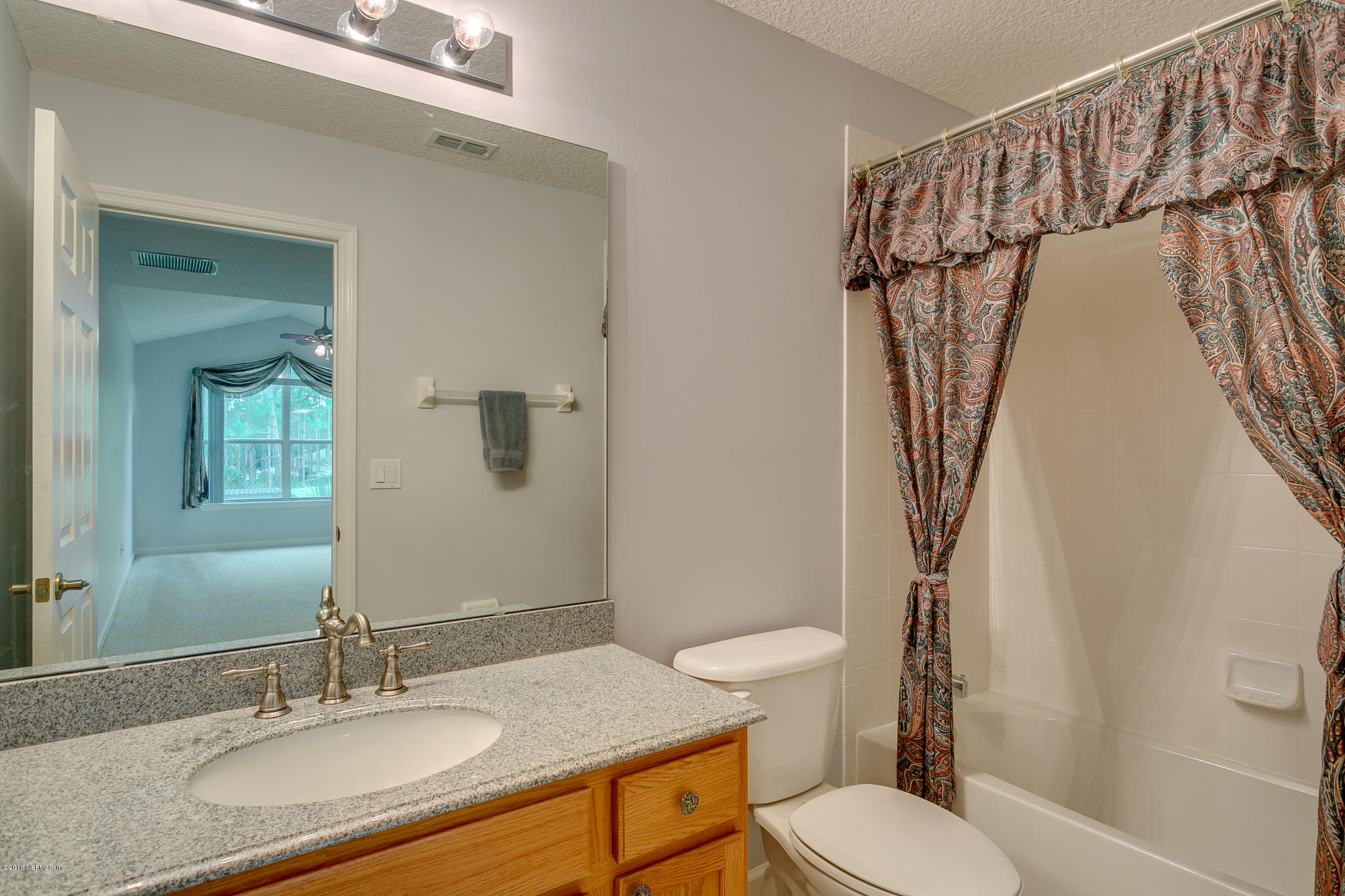 1925 Lyndhurst Drive St. Augustine, FL 32092 - Photo 38 of 52 a bathroom with a granite countertop sink toilet and shower
