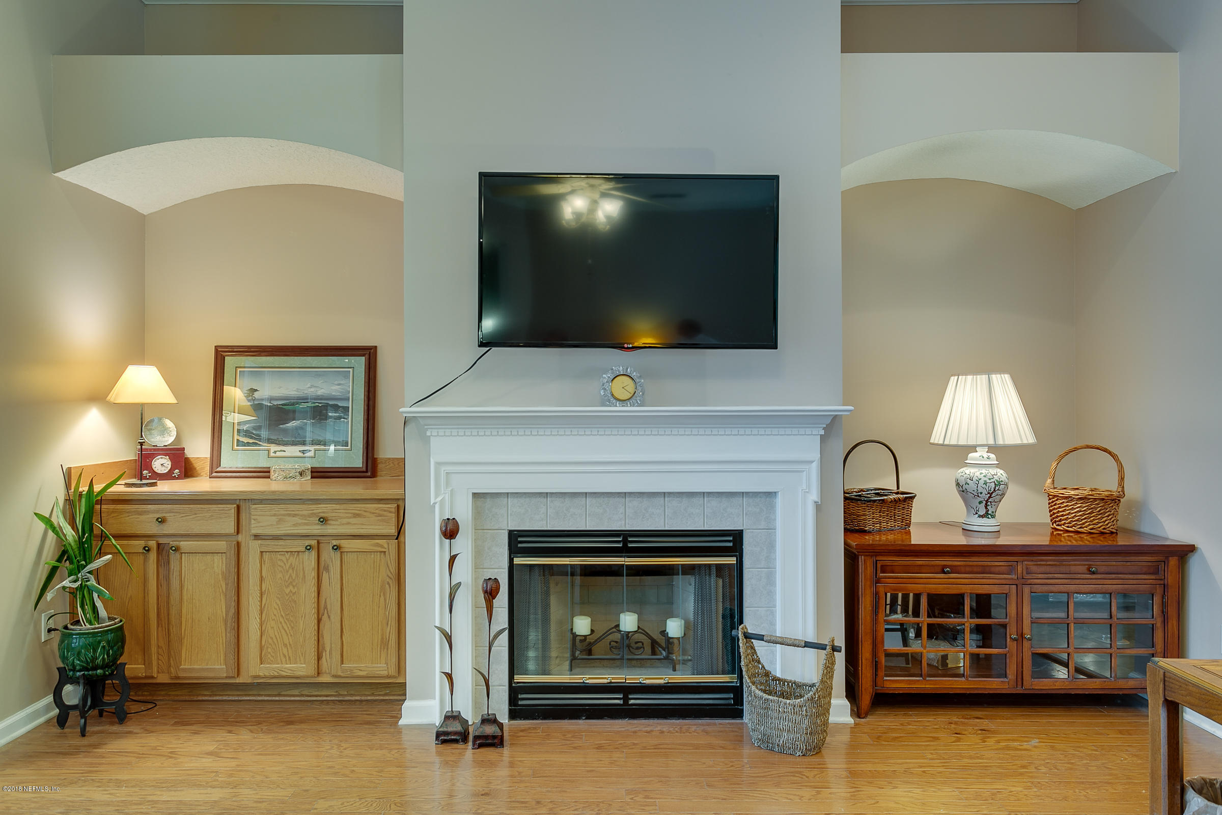 1925 Lyndhurst Drive St. Augustine, FL 32092 - Photo 9 of 52 a living room with a fireplace and a flat screen tv