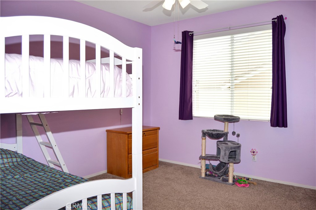 166 Fox Lane Calimesa, CA 92320 - Photo 44 of 76 2nd Bedroom with Ceiling Fan, Walk-in Closet, and Cozy Carpet