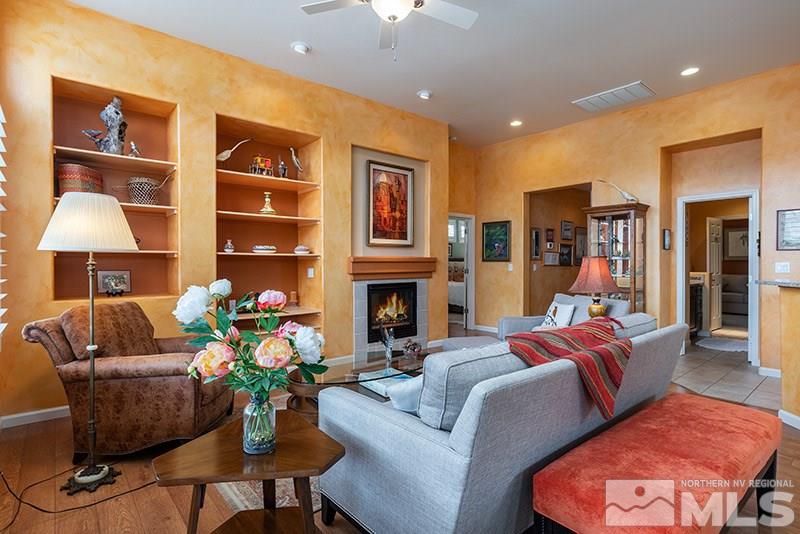 1481 Gaucho Lane Reno, NV 89521 - Photo 5 of 26 a living room with furniture fireplace and a chandelier