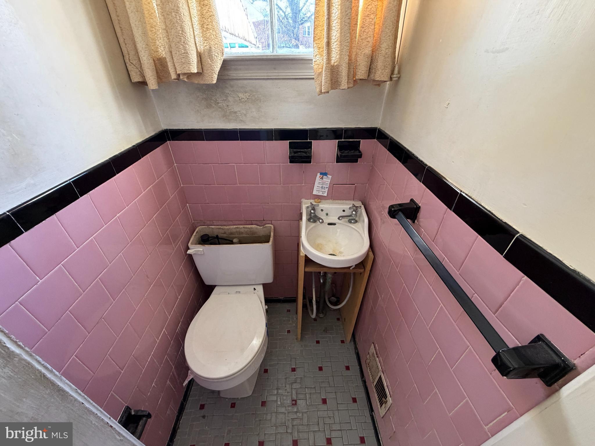 5644 Belle Avenue Baltimore, MD 21207 - Photo 12 of 14 a bathroom with a sink and a toilet