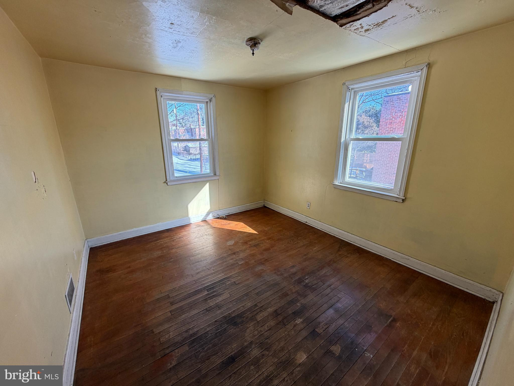 5644 Belle Avenue Baltimore, MD 21207 - Photo 7 of 14 a view of an empty room with window and wooden floor