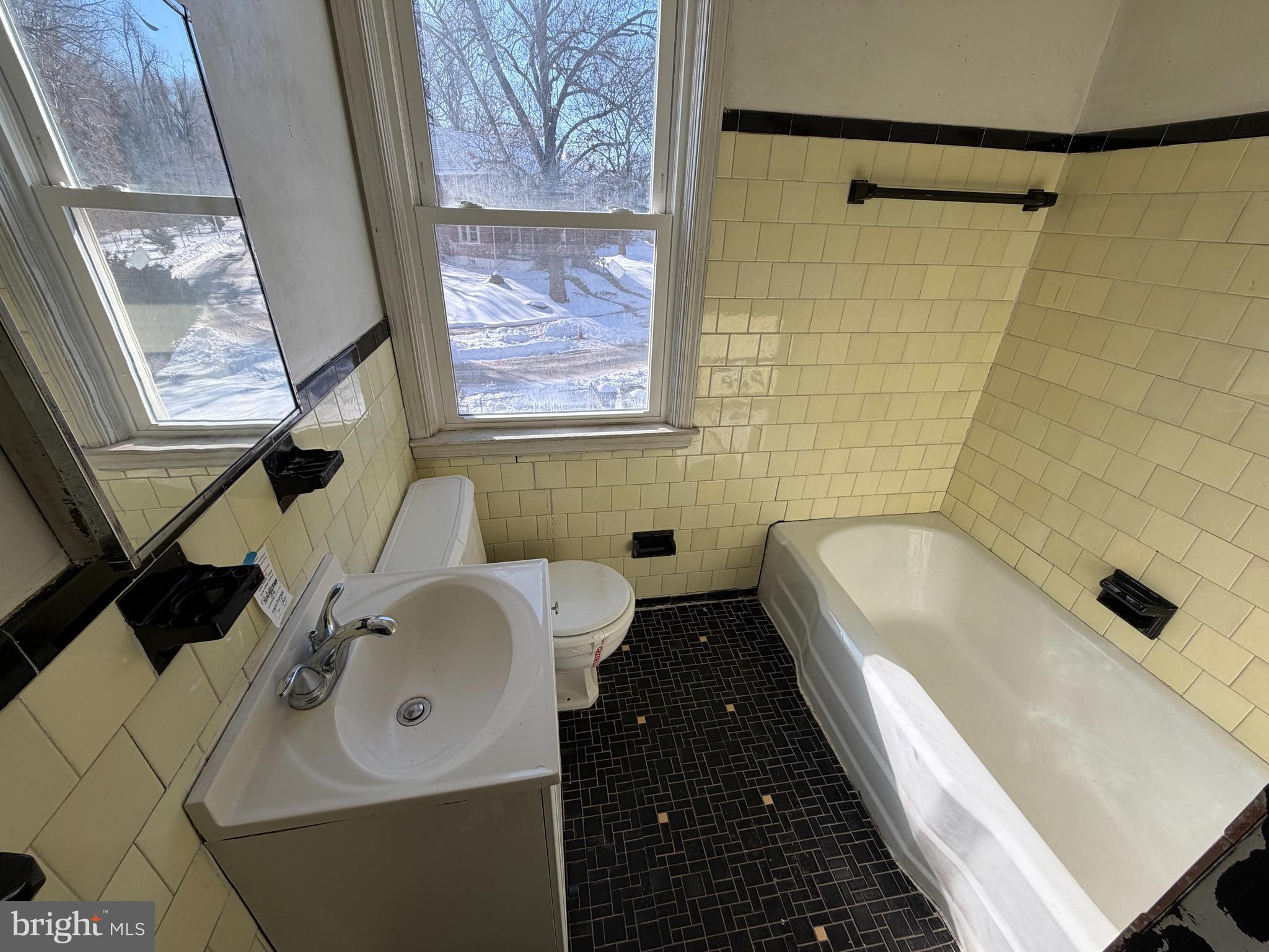 5644 Belle Avenue Baltimore, MD 21207 - Photo 9 of 14 a bathroom with a sink and a bathtub
