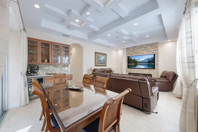 a dining room with furniture a chandelier and window