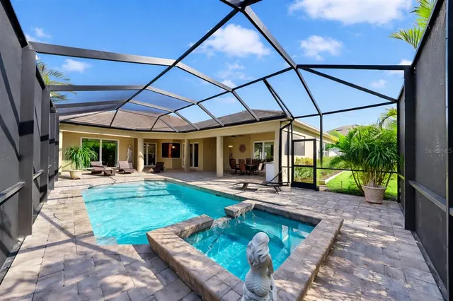 a view of a patio with table and chairs under an umbrella