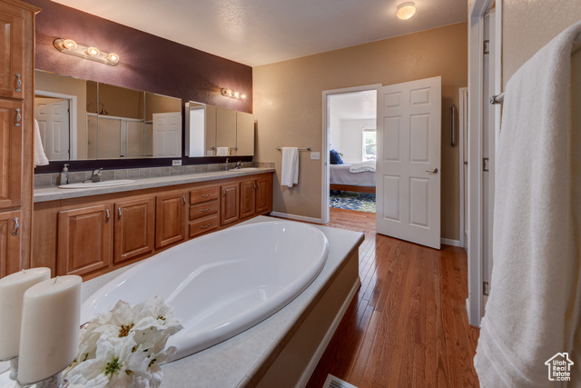 33 Merriam Court Moab, UT 84532 - Photo 17 of 56 Ensuite bathroom with a stall shower, soaking tub, double vanities, large walk-in closet, and lots of storage