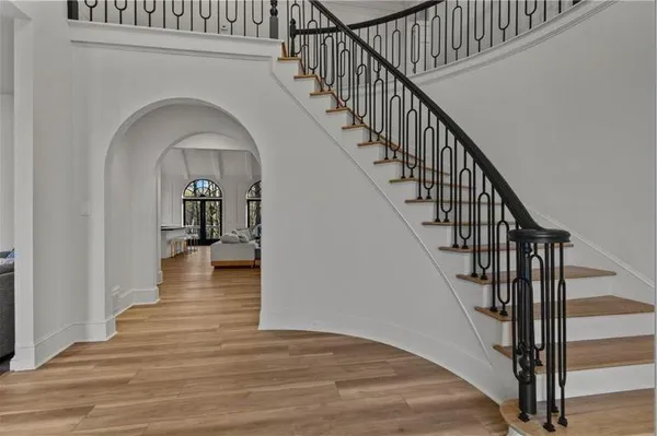 a view of entryway and hall with wooden floor