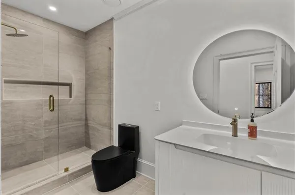 a bathroom with a toilet and a shower