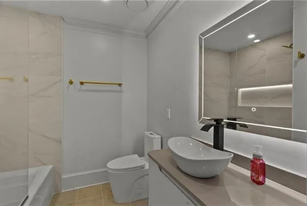 a bathroom with a toilet a sink and a mirror