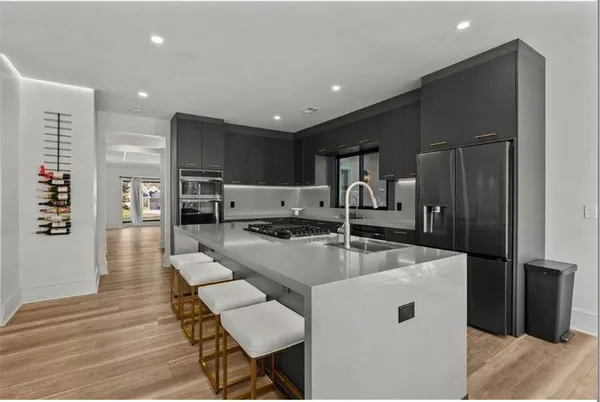 a kitchen with stainless steel appliances granite countertop a sink and stove