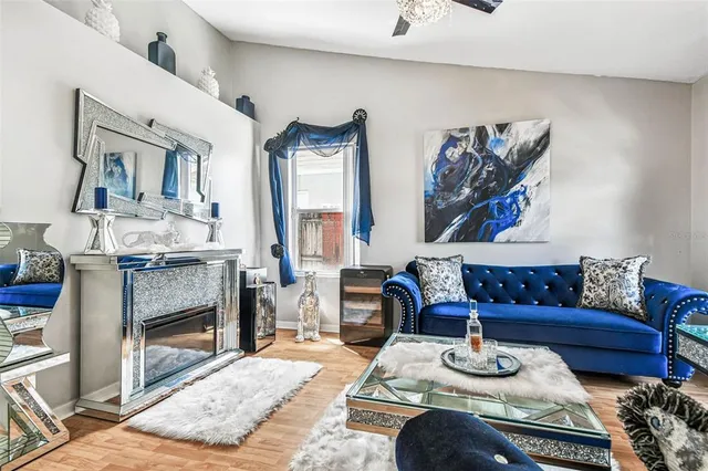 a living room with furniture a rug and a flat screen tv