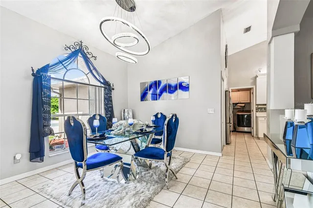 a view of a dining room with furniture wooden floor and a chandelier