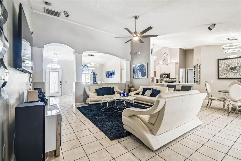 9804 Ocasta Street Riverview, FL 33569 - Photo 19 of 80 a living room with furniture a fireplace and a chandelier