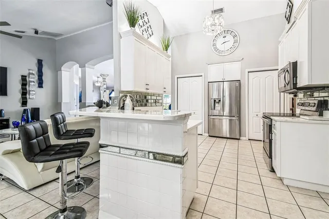 a bedroom with a bed a flat screen tv and dresser