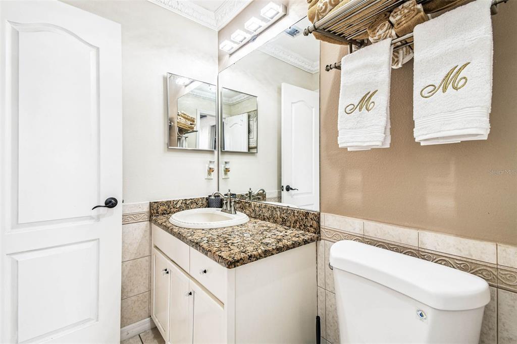 9804 Ocasta Street Riverview, FL 33569 - Photo 36 of 80 a bathroom with a granite countertop sink and a mirror