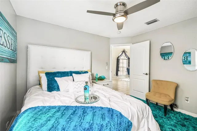 a view of a backyard with plants and wooden fence