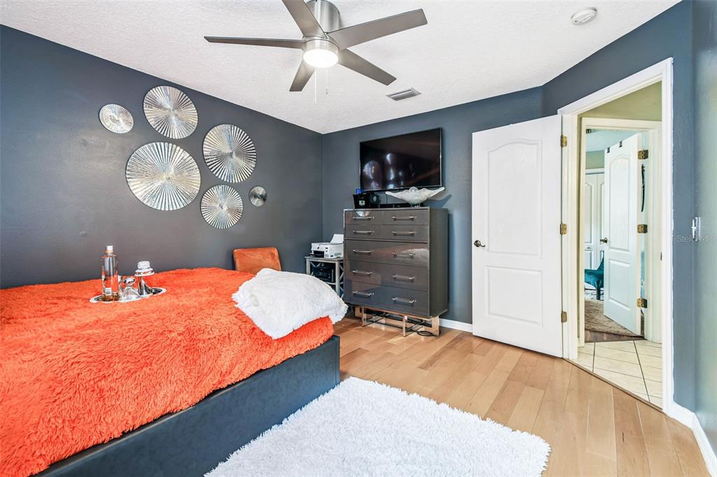 9804 Ocasta Street Riverview, FL 33569 - Photo 41 of 80 a bedroom with a bed and a chandelier