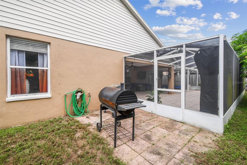 9804 Ocasta Street Riverview, FL 33569 - Photo 57 of 80 a backyard of a house with table and chairs