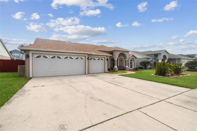 a living room with furniture a window and a potted plant