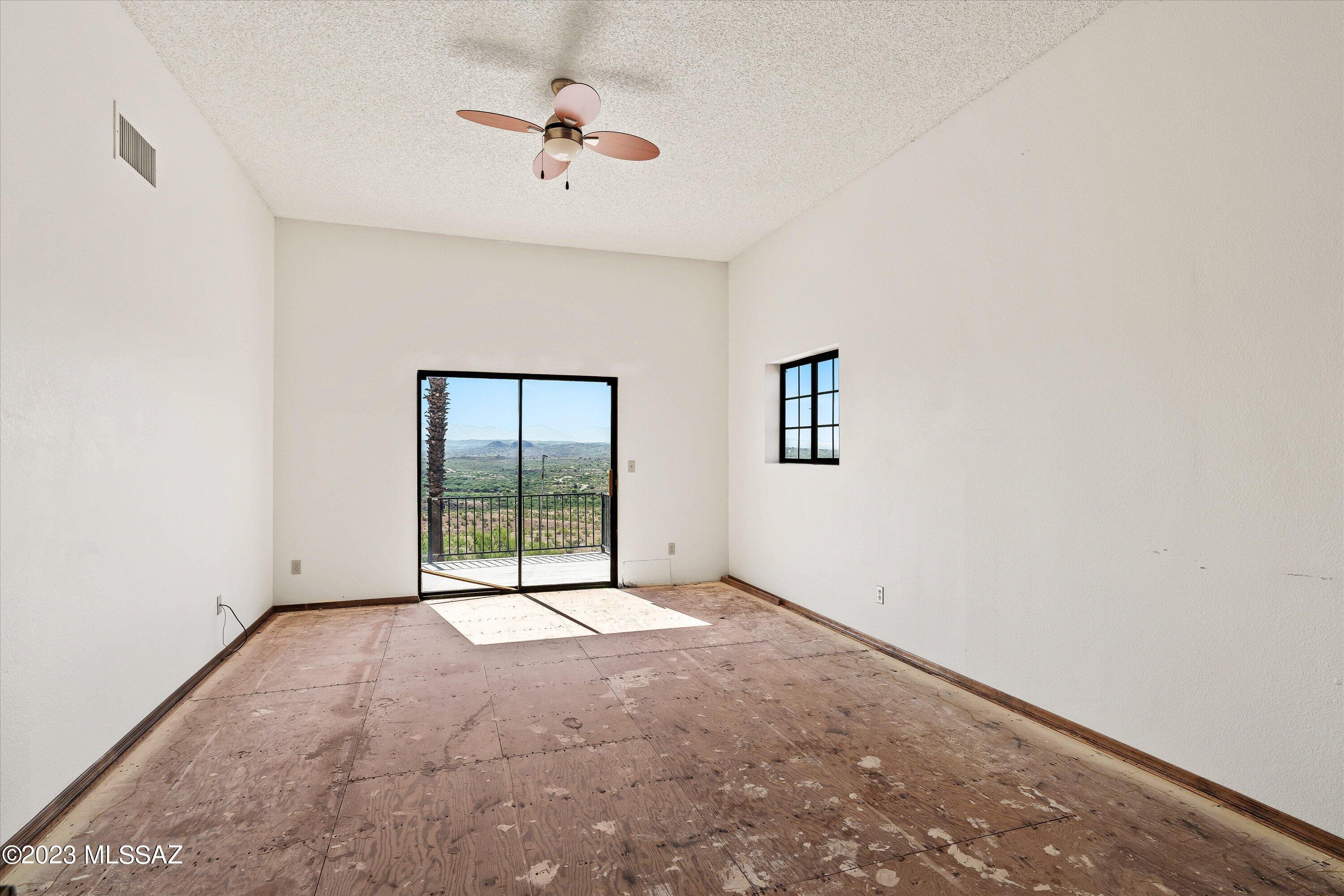 1226 Avenida Gloriosa Rio Rico, AZ 85648 - Photo 24 of 46 an empty room with windows and fan