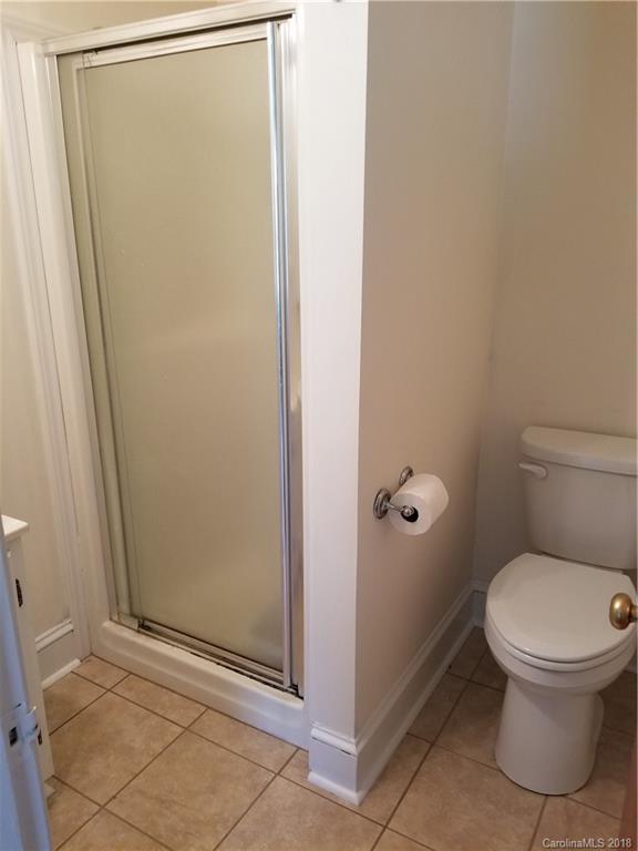 4151 Odell School Road Concord, NC 28027 - Photo 4 of 9 a bathroom with a toilet and a shower