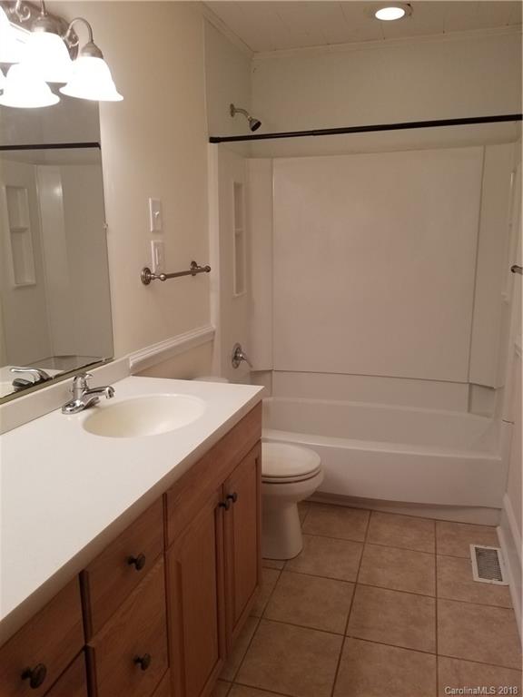 4151 Odell School Road Concord, NC 28027 - Photo 7 of 9 a bathroom with a sink a toilet and a bathtub