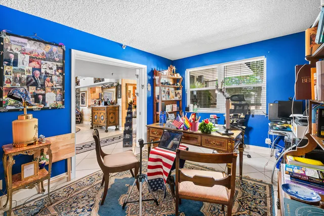 a living room with furniture a rug and a window