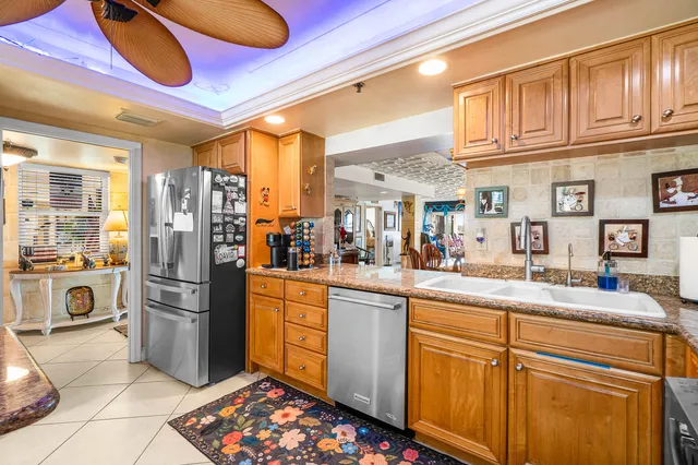 a kitchen with stainless steel appliances granite countertop a refrigerator and a stove
