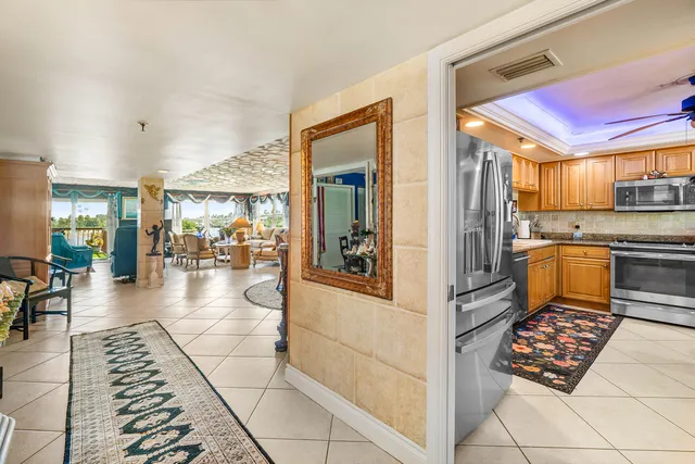 a kitchen with stainless steel appliances kitchen island granite countertop a refrigerator and a stove