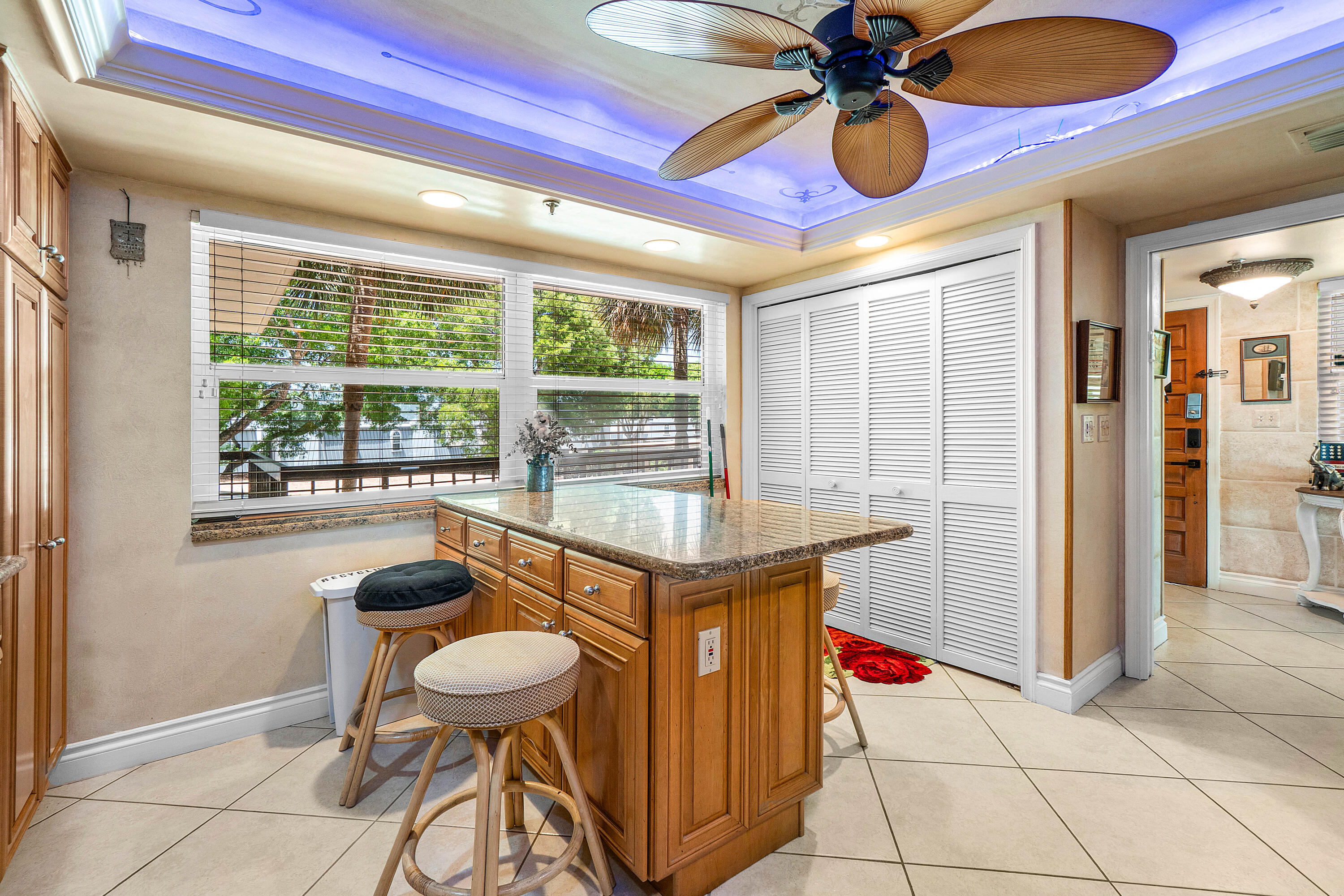 374 Golfview Road, Unit 205 North Palm Beach, FL 33408 - Photo 4 of 35 a dining room with granite countertop furniture and a floor to ceiling window
