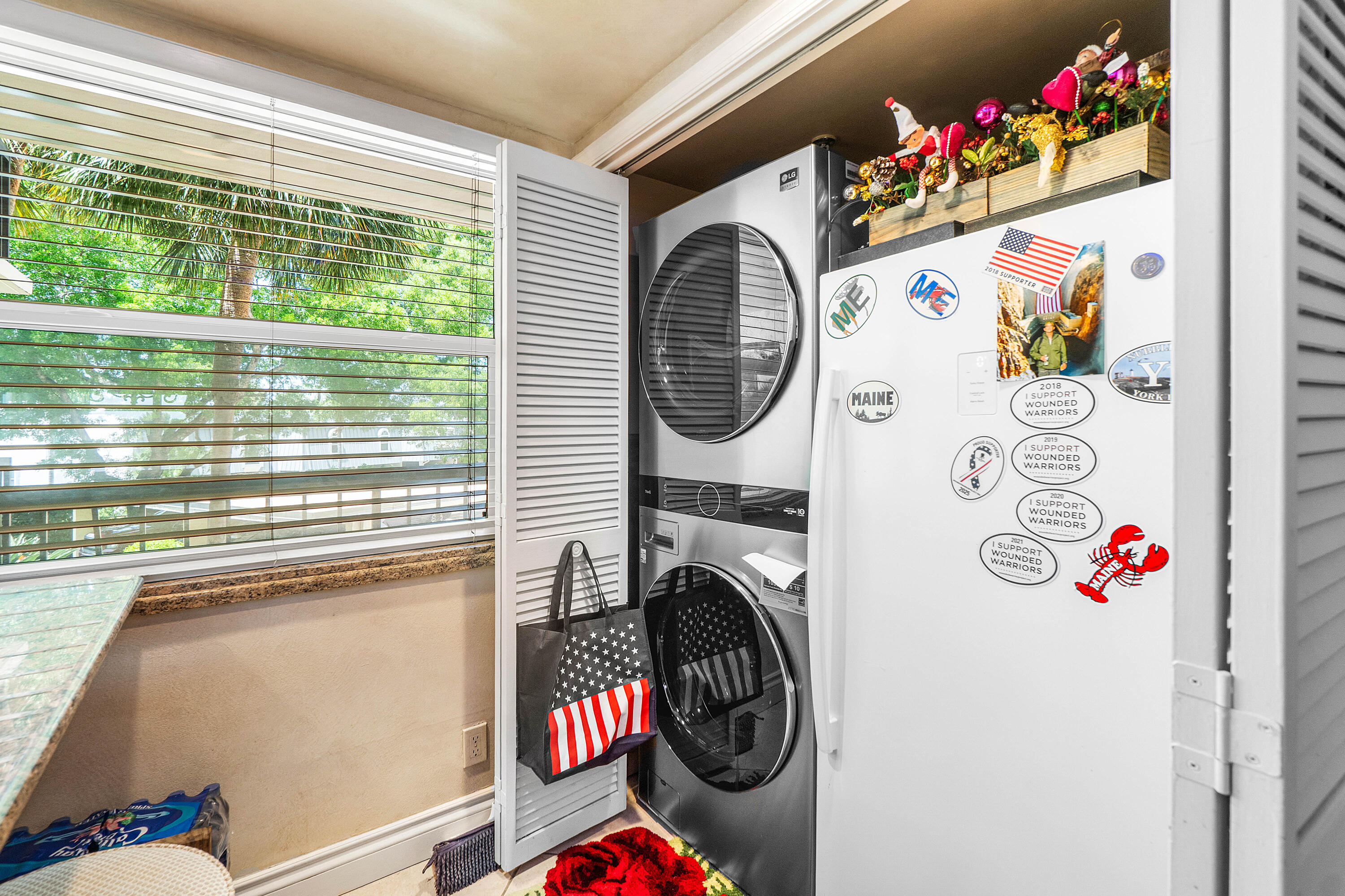 374 Golfview Road, Unit 205 North Palm Beach, FL 33408 - Photo 5 of 35 a utility room with fridge dryer and washer