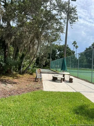 a view of backyard with a bench