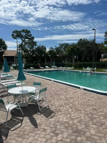 a view of a patio with a table and chairs