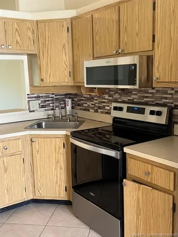 a kitchen with stainless steel appliances a stove a microwave and cabinets