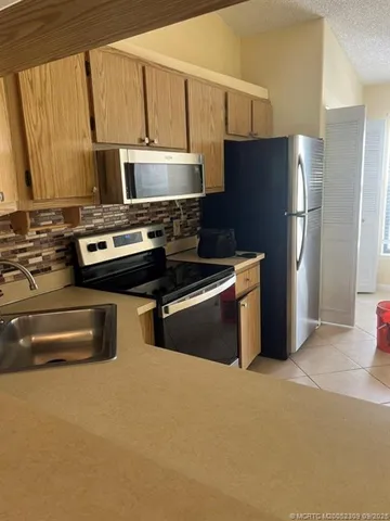 a kitchen with stainless steel appliances a refrigerator stove and microwave