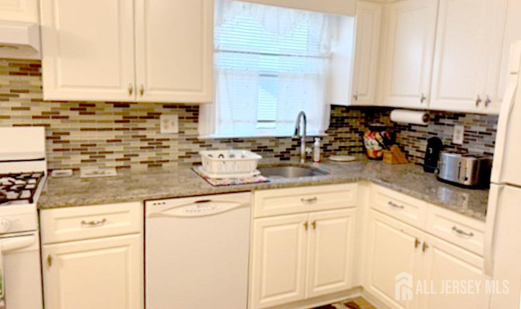 3 Adam Place Milltown, NJ 08850 - Photo 3 of 8 a kitchen with stainless steel appliances granite countertop a sink a stove and cabinets
