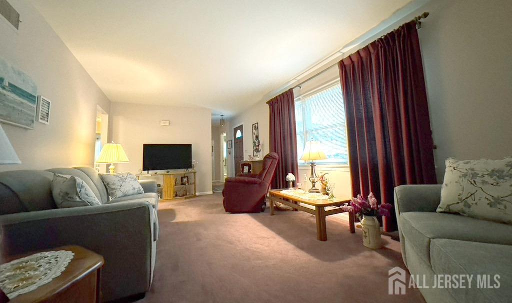 3 Adam Place Milltown, NJ 08850 - Photo 4 of 8 a living room with furniture and a flat screen tv