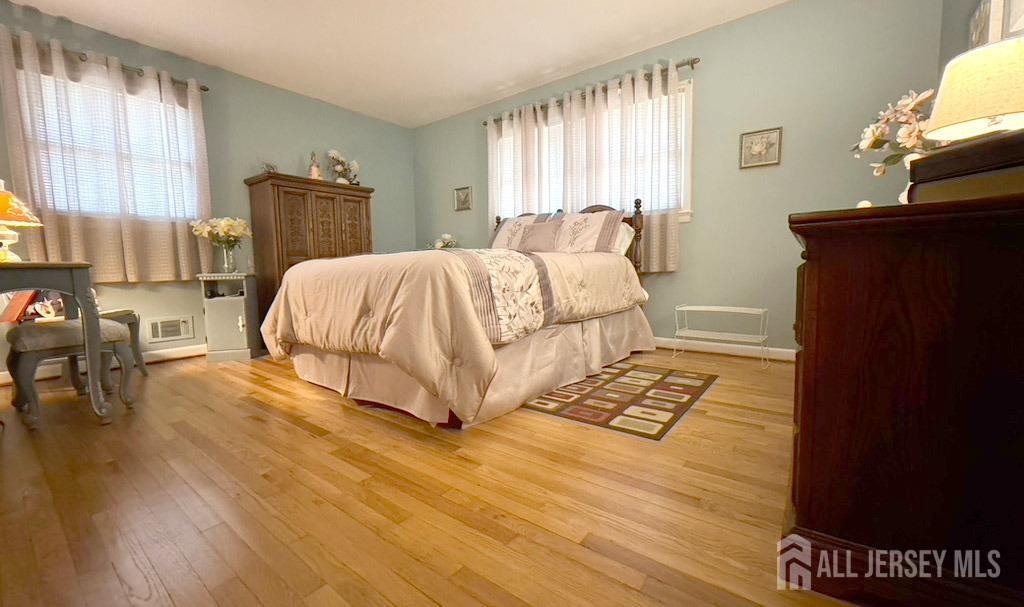 3 Adam Place Milltown, NJ 08850 - Photo 5 of 8 a bedroom with a bed and wooden floor