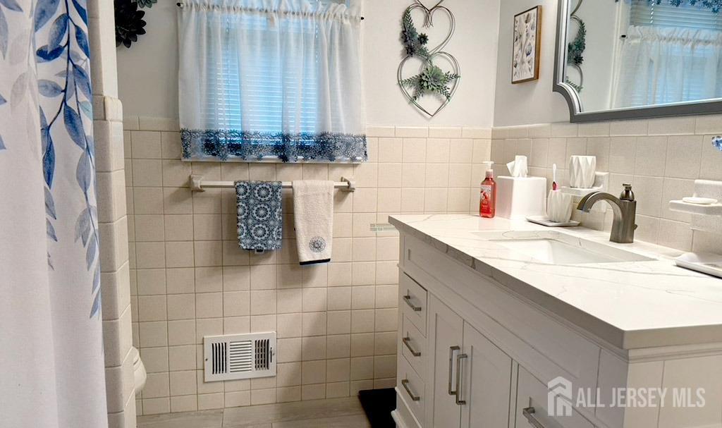3 Adam Place Milltown, NJ 08850 - Photo 8 of 8 a bathroom with a sink and a mirror