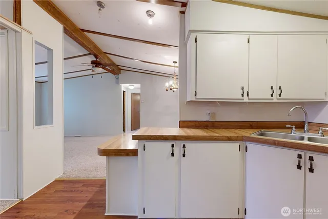 a view of a kitchen with granite countertop cabinets